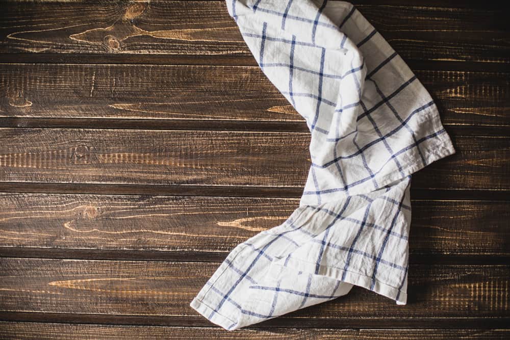 Kitchen table with a blue towel. Top view with copy space