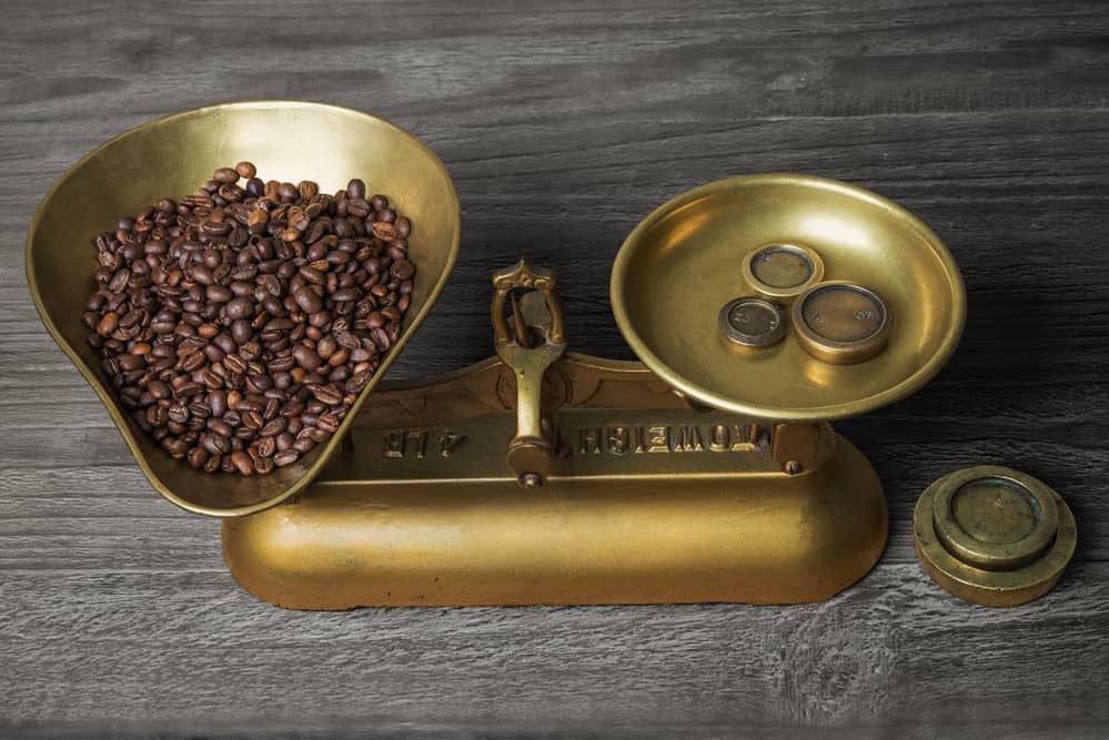old retro scales on old wooden table with coffee beans
