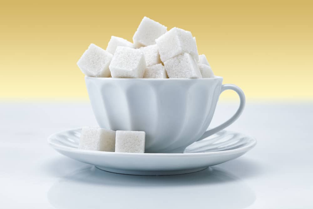 sugarcubes filling a coffee cup