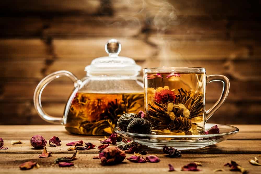 herbal tea in transparent teapot and teacup