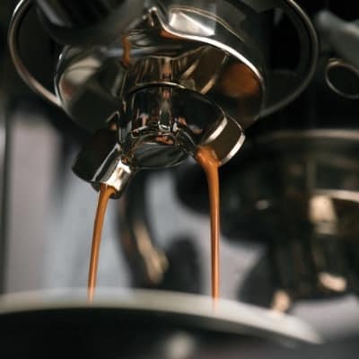 Closeup image of coffee being dispensed into a cup